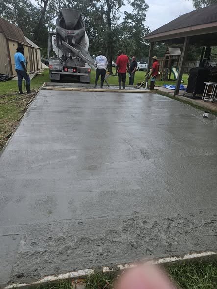 A Level Headed Construction crew screeding a freshly poured concrete foundation slab off a concrete truck in the Lake Houston area