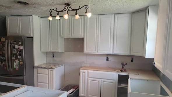 A kitchen remodel in progress by Level Headed Construction — new shaker cabinets set and an island going in