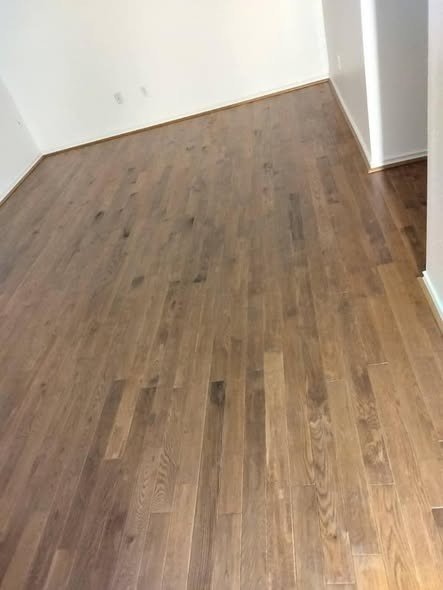 Refinished hardwood floors in an interior remodel by Level Headed Construction in the Lake Houston area